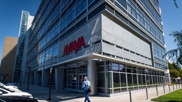 A pedestrian walks in front of Avaya Holdings Corp. headquarters in Santa Clara, California.
