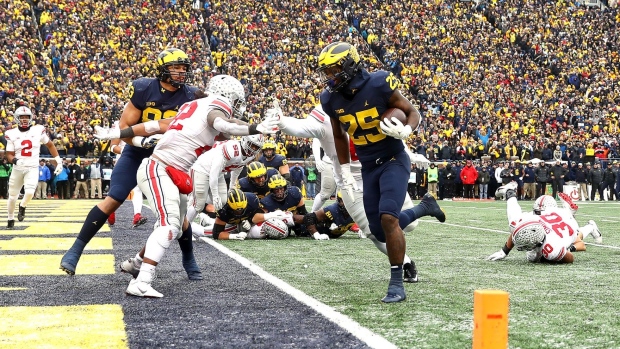  Hassan Haskins of the Michigan Wolverines carries the ball into the end zone for a touchdown against the Ohio State Buckeyes in Ann Arbor, Michigan in Nov. 2021. 