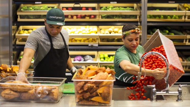 Workers prepare vegetables inside a Sweetgreen Inc. restaurant in Boston, Massachusetts, U.S., on Tuesday, Oct. 24, 2017. The fast casual dining chain Sweetgreen was founded in 2007 by three classmates from Georgetown University, and has expanded from its Washington roots to more than 80 locations nationally.