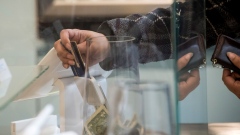 A customer inserts a credit card into Square Inc. device while making a payment in San Francisco, California.