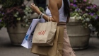 A shopper carries an H&M bag in New York, US, on Thursday, July 28, 2022. Consumer spending slowed to a 1% annualized growth rate from 1.8% for the first quarter. Photographer: Victor J. Blue/Bloomberg