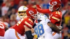 KANSAS CITY, MISSOURI - SEPTEMBER 15: Patrick Mahomes #15 of the Kansas City Chiefs is hit by Austin Johnson #98 of the Los Angeles Chargers as he throws the ball during the third quarter at Arrowhead Stadium on September 15, 2022 in Kansas City, Missouri. (Photo by David Eulitt/Getty Images)