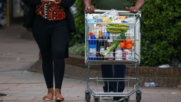 A customer pushes a shopping trolley full of groceries at an Aldi Stores Ltd. supermarket in London, UK, on Friday, June 24, 2022. The Office for National Statistics said Friday the volume of goods sold in stores and online fell 0.5% in May, as soaring food prices forced consumers to cut back on spending in supermarkets.