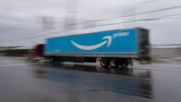 A semi truck with the Amazon.com Inc. Prime logo travels along a road outside the company's BHM1 Fulfillment Center in Bessemer, Alabama, U.S., on Saturday, Feb. 6, 2021. The campaign in Bessemer to unionize Amazon workers has drawn national attention and is widely considered a once-in-a-generation opportunity to breach the defenses of the world’s largest online retailer, which has managed to keep unions out of its U.S. operations for a quarter-century.