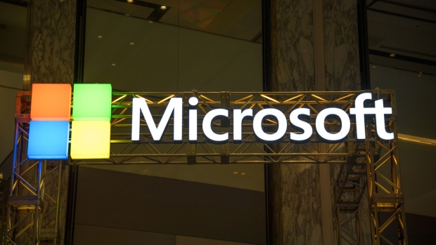 The Microsoft Corp. logo is displayed at the company's booth during the SoftBank World 2019 event in Tokyo, Japan, on Thursday, July 18, 2019. The founders of Southeast Asian ride-hailing giant Grab, indoor farming startup Plenty, Indian hotel chain OYO Rooms and payments service Paytm took the stage at an annual SoftBank conference to explain how artificial intelligence helps them stay on top in their respective fields. Photographer: Akio Kon/Bloomberg
