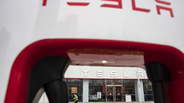 The Tesla Inc. logo is displayed on an electric vehicle charging station outside one of the company's showrooms in Beijing China, on Saturday, March 6, 2021. China, the world's biggest car market, aims to boost auto sales and add more charging facilities for electric vehicles this year. Photographer: Qilai Shen/Bloomberg