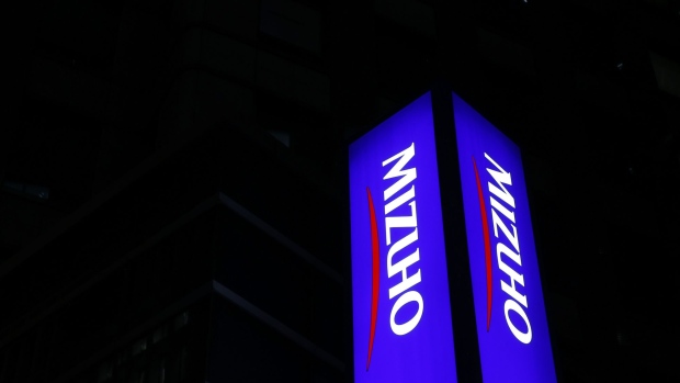 Illuminated signage for Mizuho Financial Group Inc. displayed outside a Mizuho Bank Ltd. and Mizuho Securities Co. branch at night in Tokyo, Japan, on Monday, April 25, 2022. Mizuho Securities is scheduled to release earnings figures on April 28. Photographer: Kiyoshi Ota/Bloomberg