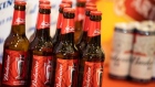 Budweiser beer products, produced by Anheuser-Busch InBev NV, sit displayed during a news conference in Hong Kong, China, on Tuesday, Sept. 17, 2019. Anheuser-Busch InBev NV is reviving the Hong Kong initial public offering of its Asian unit and is set to raise as much as $4.8 billion, roughly half of an earlier target. Photographer: Kyle Lam/Bloomberg