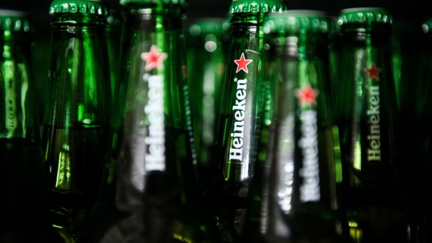 Heineken logos sit on the necks of beer bottles inside the Heineken Hungaria Breweries Plc Sopron brewery in Sopron, Hungary.