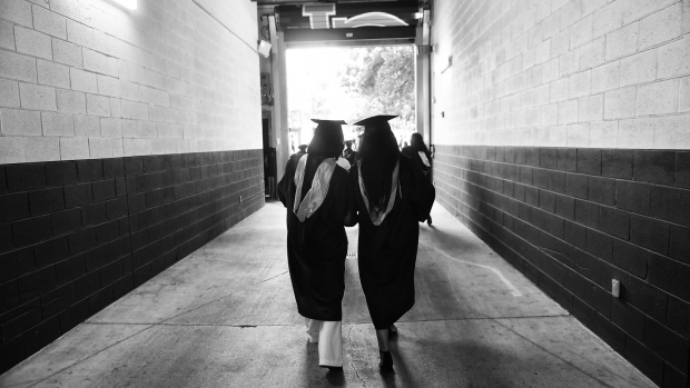 ATLANTA, GEORGIA - MAY 16: (EDITORS NOTE: Image has been converted to black and white.) Spelman College graduates walking during the 2020 & 2021 Spelman College Commencement at Bobby Dodd Stadium on May 16, 2021 in Atlanta, Georgia. Spelman commencement activities took place over 2 ceremonies for each graduating classes. The 2020 commencement exercises were postponed last year because of the ongoing global COVID-19 pandemic. (Photo by Paras Griffin/Getty Images)