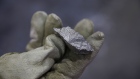 A worker holds a chunk of Bessemer matte at the Vale Copper Cliff Smelter Complex in Sudbury, Ontario, Canada, on Wednesday, June 1, 2022. Nickel is the key ingredient in the stainless steel used in everyday appliances, but it's also critical for the transition away from fossil fuels, since it's used in the batteries automakers need to electrify the world’s car fleet.