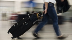 A traveler pulls luggage through Toronto Pearson International Airport (YYZ) in Toronto, Ontario, Canada, on Monday, July 22, 2019. In 2018, 49.5 million passengers traveled through Pearson on 473,000 flights.