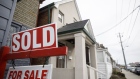A "Sold" sign in front of a home in the York neighborhood of Toronto, Ontario, Canada, on Thursday, March 11, 2021. The buying, selling and building of homes in Canada takes up a larger share of the economy than it does in any other developed country in the world, according to the Bank of International Settlements, and also soaks up a larger share of investment capital than in any of Canada’s peers.
