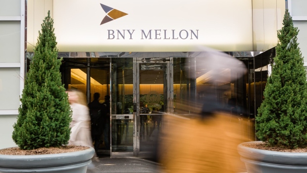 Pedestrians walk in front of a Bank of New York Mellon Corp. office building in New York, U.S., on Monday, Jan. 13, 2020. BNY Mellon is scheduled to release earnings figures on January 16. Photographer: Gabriela Bhaskar/Bloomberg