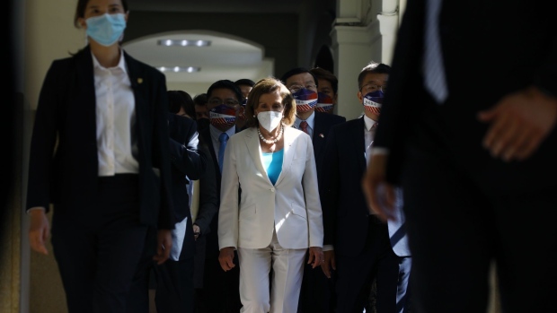 Nancy Pelosi, center, arrives at the Legislative Yuan in Taipei, Taiwan, in Aug. 2022.  Photographer: I-Hwa Cheng/Bloomberg