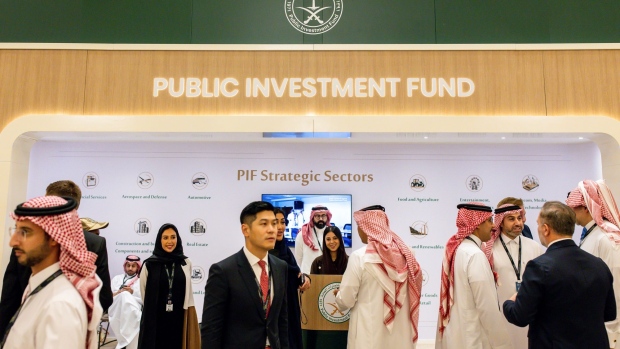 Attendees visit the Public Investment Fund (PIF) booth on day two of the Future Investment Initiative (FII) conference in Riyadh, Saudi Arabia, on Wednesday, Oct. 26, 2022. Saudi Arabia hopes the FII will put Riyadh on the map as a global destination for deals, while also improving domestic investment, which has been limited. Photographer: Tasneem Alsultan/Bloomberg