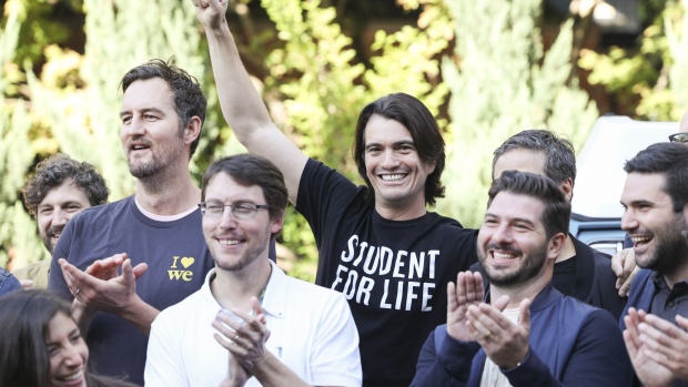 Miguel McKelvey, right, and Adam Neumann, co-founders of WeWork, during a group photograph at an event on the sidelines of the company's trading debut in New York, U.S., on Thursday, Oct. 21, 2021. As WeWork completes its second attempt to go public, this time through a SPAC valuing the combined company at $9 billion, Neumann's name is peppered 197 times throughout the business combination filing, even though he's no longer an employee or board member.