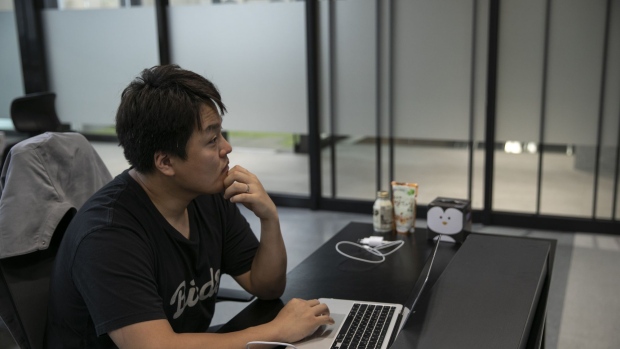 Do Kwon, co-founder and chief executive officer of Terraform Labs, works on his laptop in the company's office in Seoul, South Korea, on Thursday, April 14, 2022. Kwon is counting on the oldest cryptocurrency as a backstop for his stablecoin, which some critics liken to a ginormous Ponzi scheme.