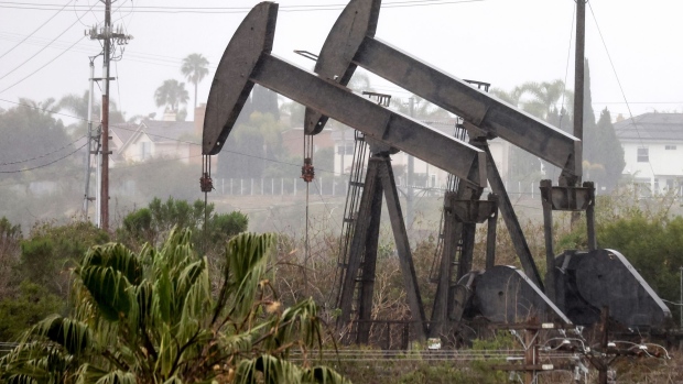 LOS ANGELES, CALIFORNIA - MARCH 28: An oil pumpjack (R) operates as another (C) stands idle on March 28, 2022 in Los Angeles, California. U.S. oil prices fell 7 percent to $105.96 per barrel while Brent crude lost 6.8 percent over demand concerns as China begins to implement a mass COVID-19 lockdown in Shanghai. (Photo by Mario Tama/Getty Images)