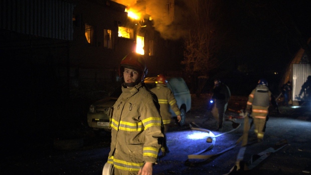 Firefighters at the scene of a Russian drone attack in Kyiv on March 28. Photographer: Sergey Shestak/AFP/Getty Images