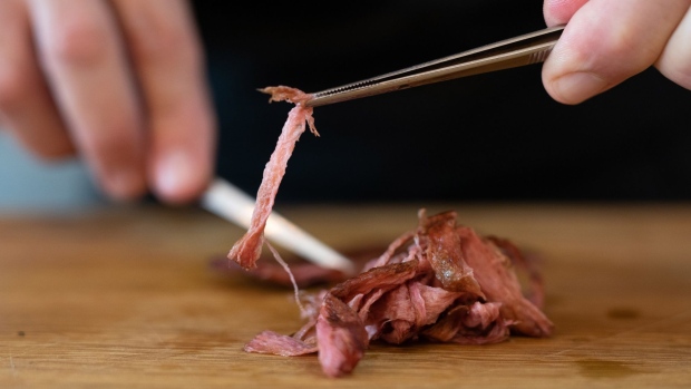 A chef shreds a piece of cultivated thin-cut steak in the Aleph Farms Ltd. development kitchen in Rehovot, Israel, on Sunday, Nov. 27, 2022. The UN predicted last year that with the world's population expected to climb by 11% in the coming decade, meat consumption would rise by an even greater 14%. Photographer: Corinna Kern/Bloomberg
