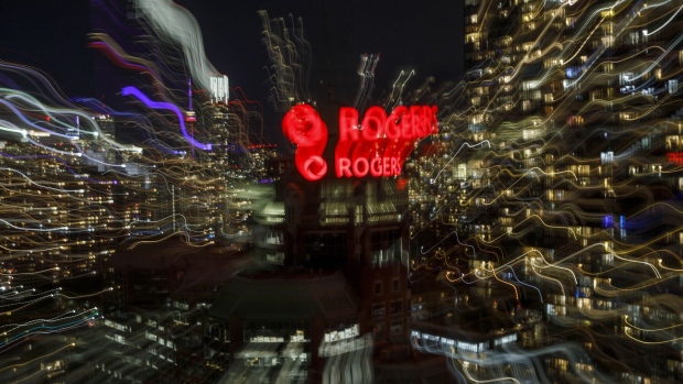 Rogers Communications Inc. logo displayed atop the the company's headquarters in Toronto, Ontario, Canada, on Sunday, Oct. 24, 2021. The family squabble at Rogers Communications Inc. carried into the weekend with Edward Rogers planning to convene a board meeting of who he believes are the new directors the Canadian telecommunications company. Photographer: Cole Burston/Bloomberg