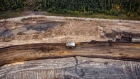 A heavy hauler truck drives through the Albian Sands Energy Inc. Muskeg River mine in this aerial photograph taken above the Athabasca oil sands near Fort McMurray, Alberta, Canada, on Monday, Sept. 10, 2018. While the upfront spending on a mine tends to be costlier than developing more common oil-sands wells, their decades-long lifespans can make them lucrative in the future for companies willing to wait.