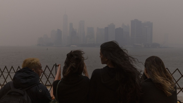 Passengers on the Staten Island Ferry look out over Lower Manhattan as it is shrouded in smoke from Canada wildfires in New York, US, on Wednesday, June 7, 2023. The US Northeast, including New York City, will continue to breathe in choking smoke from fires across eastern Canada for the next few days, raising health alarms across impacted areas.