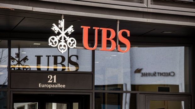 Signage above the entrance to a UBS Group AG bank branch in Zurich, Switzerland, on Friday, March 17, 2023. UBS and Credit Suisse Group AG are opposed to a forced combination, even as scenario planning for a government-orchestrated tie-up continues, according to people with knowledge of the matter.