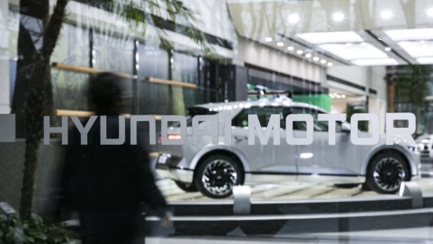 Signage outside the lobby of the Hyundai Motor Co. headquarters building in Seoul, South Korea, on Thursday, Dec. 15, 2022. Hyundai, now the world’s third-largest carmaker behind Toyota Motor Corp. and Volkswagen AG, is duking it out with Ford Motor Co. for second place in US electric vehicle sales this year, behind Tesla Inc. Photographer: Woohae Cho/Bloomberg
