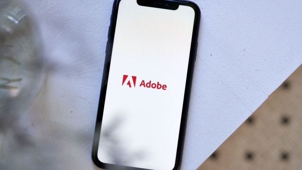 The Adobe logo on a smartphone arranged in the Brooklyn borough of New York, US, on Friday, July 28, 2023. Adobe Inc.s $20 billion takeover of design startup Figma Inc. is on course for an in-depth investigation from European Union merger regulators, adding to growing global scrutiny of the deal dubbed by Adobes boss as transformational. Photographer: Gabby Jones/Bloomberg