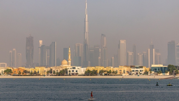 A fly boarder passes the Burj Khalifa skyscraper, center, on the city skyline in the Jumeirah Beach district of Dubai, United Arab Emirates, on Friday, Aug. 25, 2023. Chinese investors are gradually returning to Dubai’s real estate market, joining Russian and other international buyers who have already pushed property prices in the emirate to record levels.