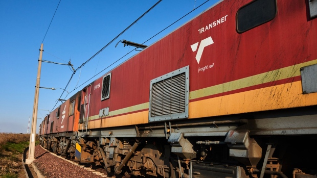 The locomotive of a Transnet SOC Ltd. freight train transports wagons of coal from the Mafube open-cast coal mine, operated by Exxaro Resources Ltd. and Thungela Resources Ltd., towards Richard's Bay coal terminal, in Mpumalanga, South Africa on Thursday, Sept. 29, 2022. South Africa relies on coal to generate more than 80% of its electricity, and has been subjected to intermittent outages since 2008 because state utility Eskom Holdings SOC Ltd. can't meet demand from its old and poorly maintained plants.