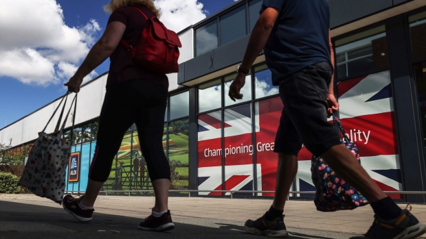 Shoppers outside an Aldi Stores Ltd. supermarket in Strood, UK, on Tuesday, Aug. 15, 2023. Grocery price inflation has fallen sharply, another sign that Britain’s cost-of-living crisis is gradually easing for consumers. Photographer: Hollie Adams/Bloomberg