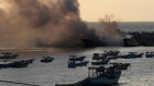 Smoke rises from burning fishing boats