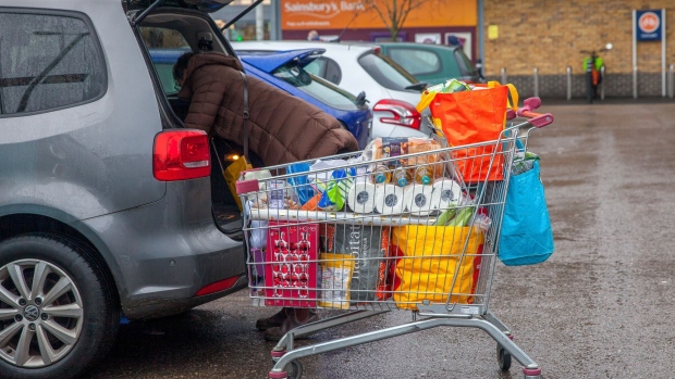 A customer loads her car with groceries from Sainsbury's supermarket in Dulwich, London, U.K., on Monday, Dec. 21, 2020. The U.K. confronted threats of food insecurity and panicked shopping days before Christmas as European nations restricted trade and travel to guard against a resurgent coronavirus, offering Britain a preview of the border chaos to come in the absence of a Brexit deal. Photographer: Betty Laura Zapata/Bloomberg