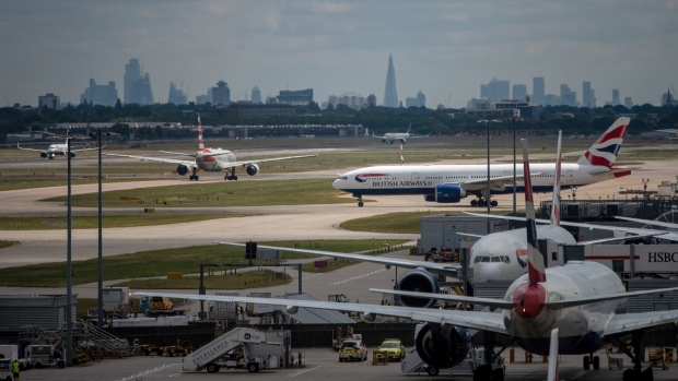 Passenger aircraft, operated by British Airways, a unit of International Consolidated Airlines Group SA (IAG), taxi at London Heathrow Airport in London, UK, on Monday, June 13, 2022. Heathrow airport said its policy of carefully matching flight availability to resources as travel rebounds has been vindicated, citing a lack of disruption even as customer numbers reached their highest level since the start of the pandemic.