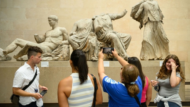 Visitors view the Elgin Marbles at the Museum of London.