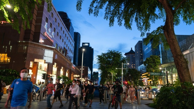 Pedestrians pass along Orchard Road in Singapore, on Saturday, July 25, 2020. Singapore’s economy plunged into recession last quarter as an extended lockdown shuttered businesses and decimated retail spending, a sign of the pain the pandemic is wreaking across export-reliant Asian nations.