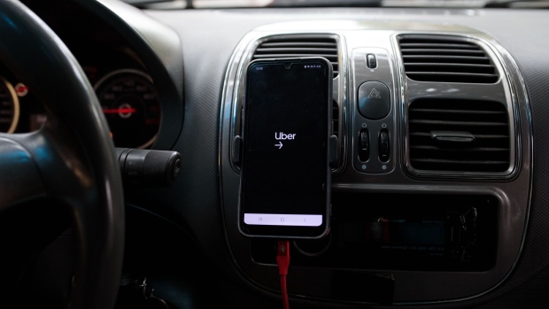 A smartphone with an Uber application inside a vehicle in Sao Paulo, Brazil, on Sunday, Oct. 17, 2021. Uber is now allowing some users in Brazil to pay more for shorter wait times, as high gas prices have led to a dearth of drivers.