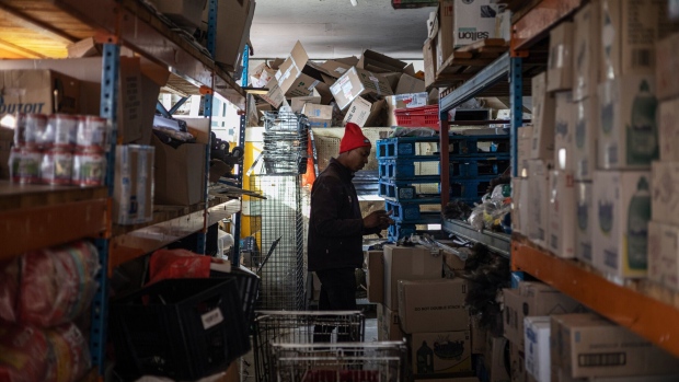 A worker sorts products in the storeroom of the OK Foods supermarket in Frankfort, South Africa, on Friday, June 2, 2023. The rural town of Frankfort has returned into scheduled blackouts, following a court-issued ban sought by Eskom Holdings SOC Ltd. against Rural Free State (Pty) Ltd., who were easing loadshedding schedules for residents by providing power from a local photovoltaic solar plant.