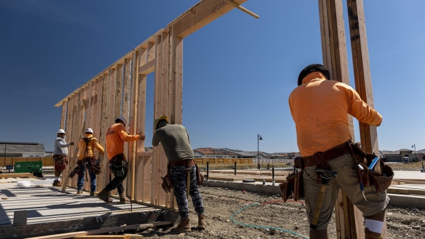 Contractors raise a framed wall on a house under construction at the Toll Brothers Regency at Folsom Ranch community in Folsom, California, US, on Thursday, May 18, 2023. US housing starts increased in April, adding to evidence that residential real estate is gradually recovering after a yearlong slump.