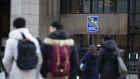 People walk by an RBC sign