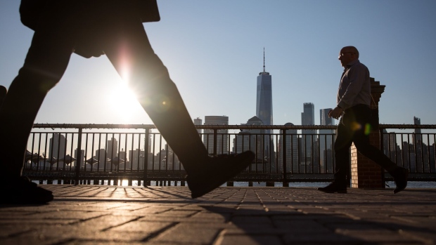 Pedestrians walk along the Hudson River Waterfront Walkway in Jersey City, New Jersey, U.S., on Tuesday, April 23, 2019. U.S. equities climbed on the back of better-than-forecast earnings, while the dollar strengthened and Treasury yields dipped. Photographer: Michael Nagle/Bloomberg
