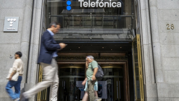 Pedestrians pass the Telefonica SA flagship store on Gran Via in central Madrid, Spain, on Wednesday, Sept. 6, 2023. Telefonica SA’s shares rose after Saudi Telecom Co. took a stake worth $2.25 billion in the Madrid-based carrier as it prepares to lay out a new strategy for future growth. Photographer: Paul Hanna/Bloomberg
