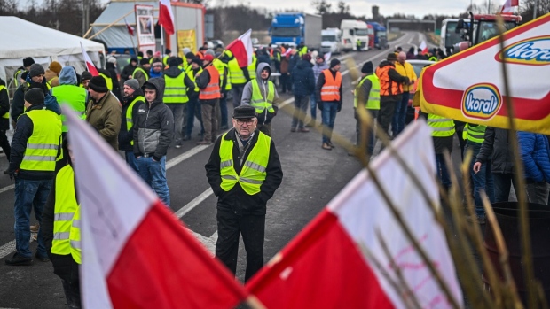 DOROHUSK, POLAND - FEBRUARY 20: Polish farmers walk around as they take part in a blockade protest at the Dorohusk Polish-Ukrainian border crossing on February 20, 2024 in Dorohusk, Poland. The long-running blockade centers on demands by Polish farmers and truckers to restrict imports of Ukrainian agricultural products. (Photo by Omar Marques/Getty Images)