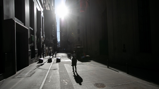 Pedestrians walk along Wall Street in New York. Photographer: Michael Nagle/Bloomberg