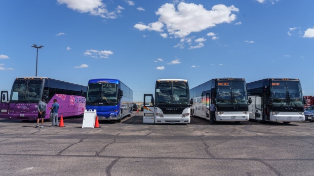 Buses chartered for transporting migrants to Chicago or New York are parked outside the Migrant Welcome Center in El Paso, Texas, US, on Thursday, Sept. 22, 2022. 