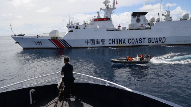 A Chinese coast guard ship (R) blocks a Philippine Bureau of Fisheries and Aquatic Resources ship near the Chinese-controlled Scarborough Shoal in the disputed South China Sea on Sept. 22, 2023. Photographer: Ted Aljibe/AFP/Getty Images