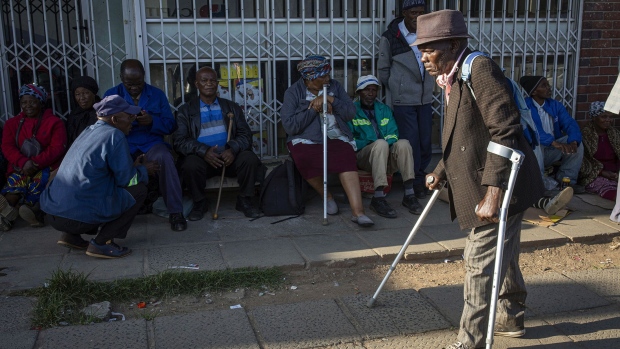 <p>Pensioners wait in line early in the morning to collect their state pension at the Mthatha Post Office in Mthatha, Eastern Cape Province, South Africa, on Feb. 2.</p>